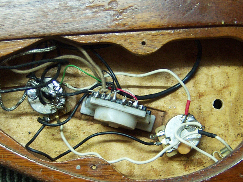 The old messy wiring from the guitar.